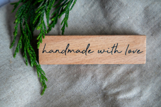 A piece of wood that says handmade with love