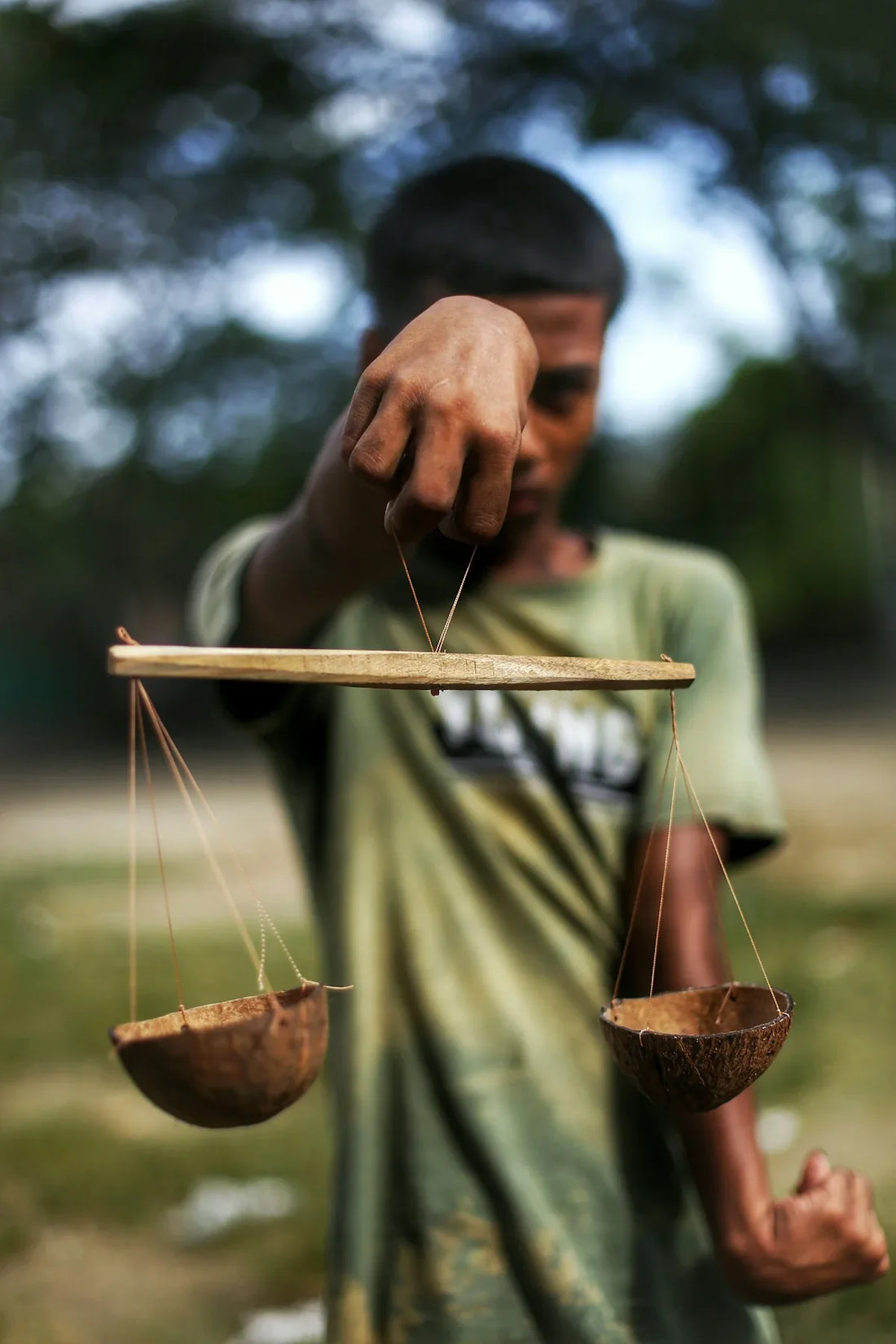 A man holding a balance scale with two hands
